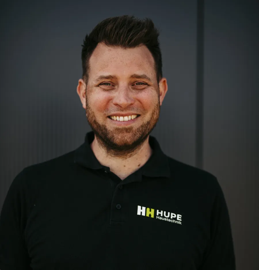 Björn Hupe, Installateur- und Heizungsbaumeister, lächelnd im schwarzen Hupe-Poloshirt